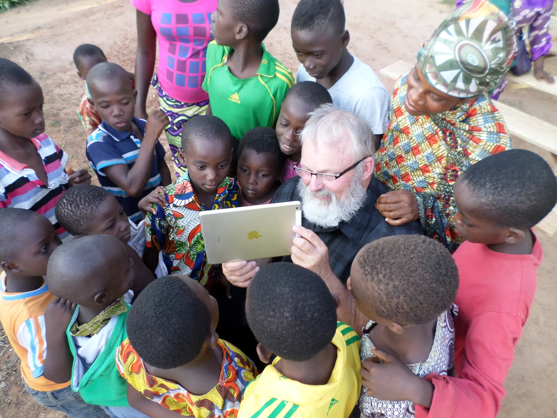 A missionary sharing a learning moment with children in a village