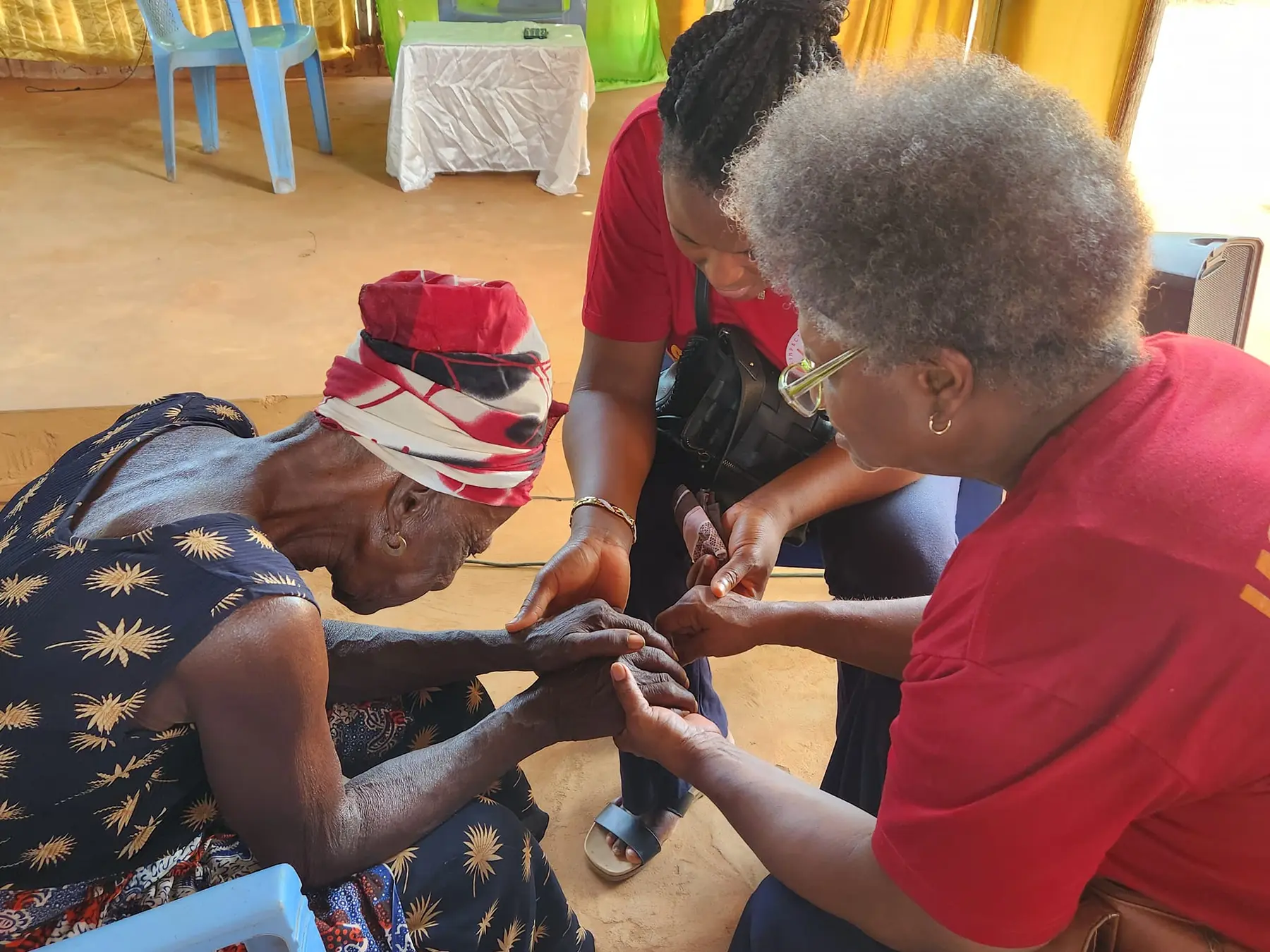 Lasting Impact Mission volunteers caring for an elderly woman